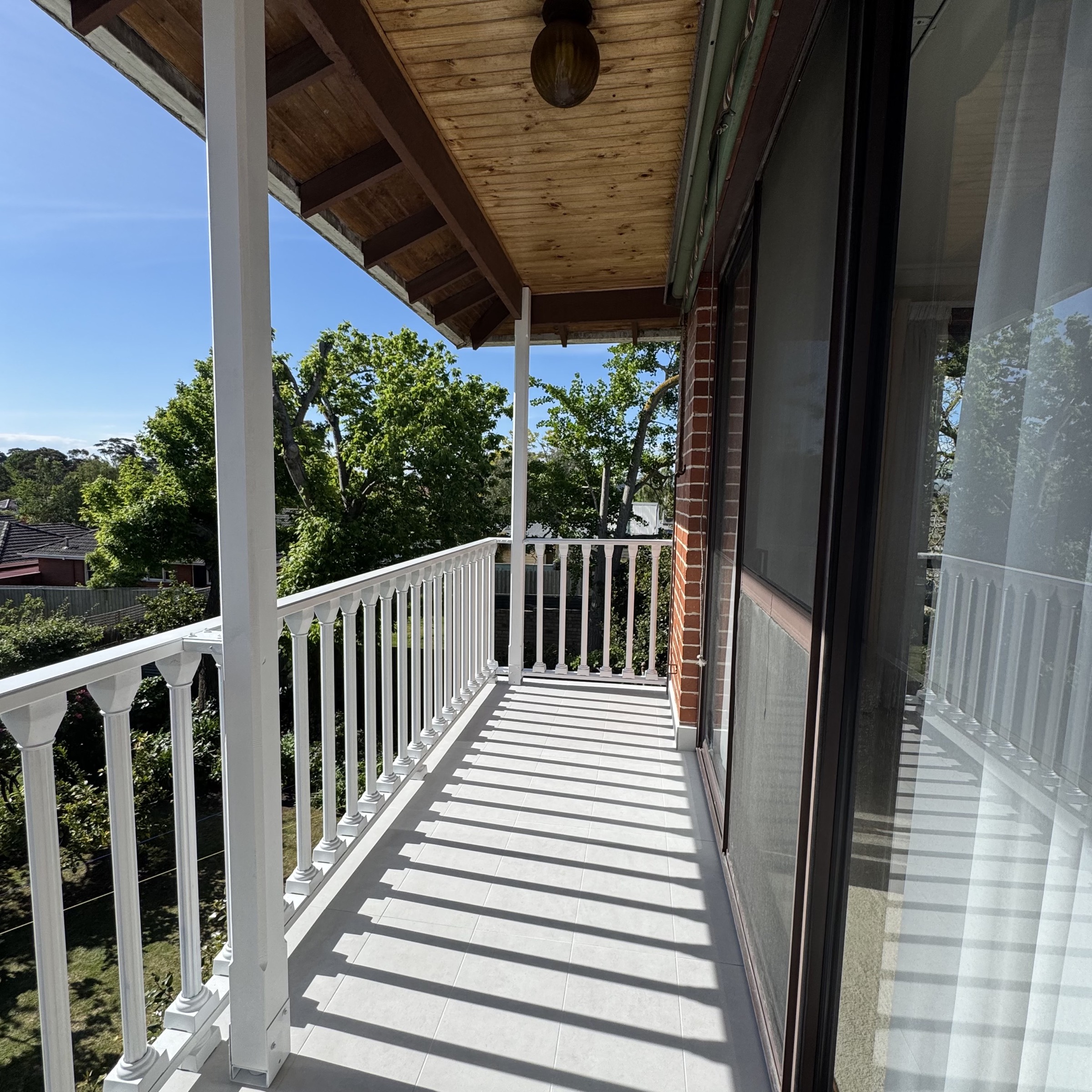 Completed tiled balcony with restored white balustrade