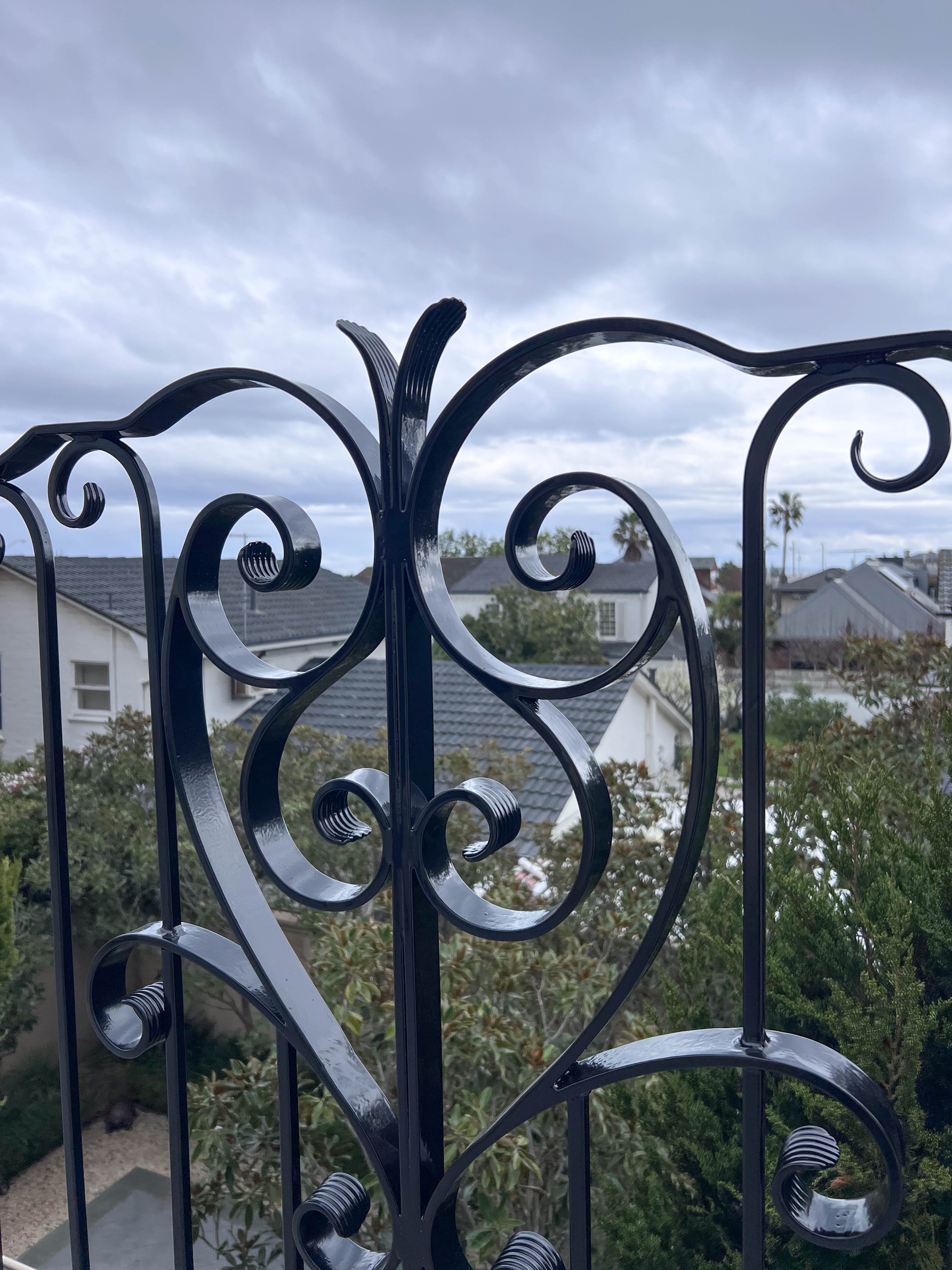 Restored decorative wrought-iron balustrade after powder coating and reinstallation