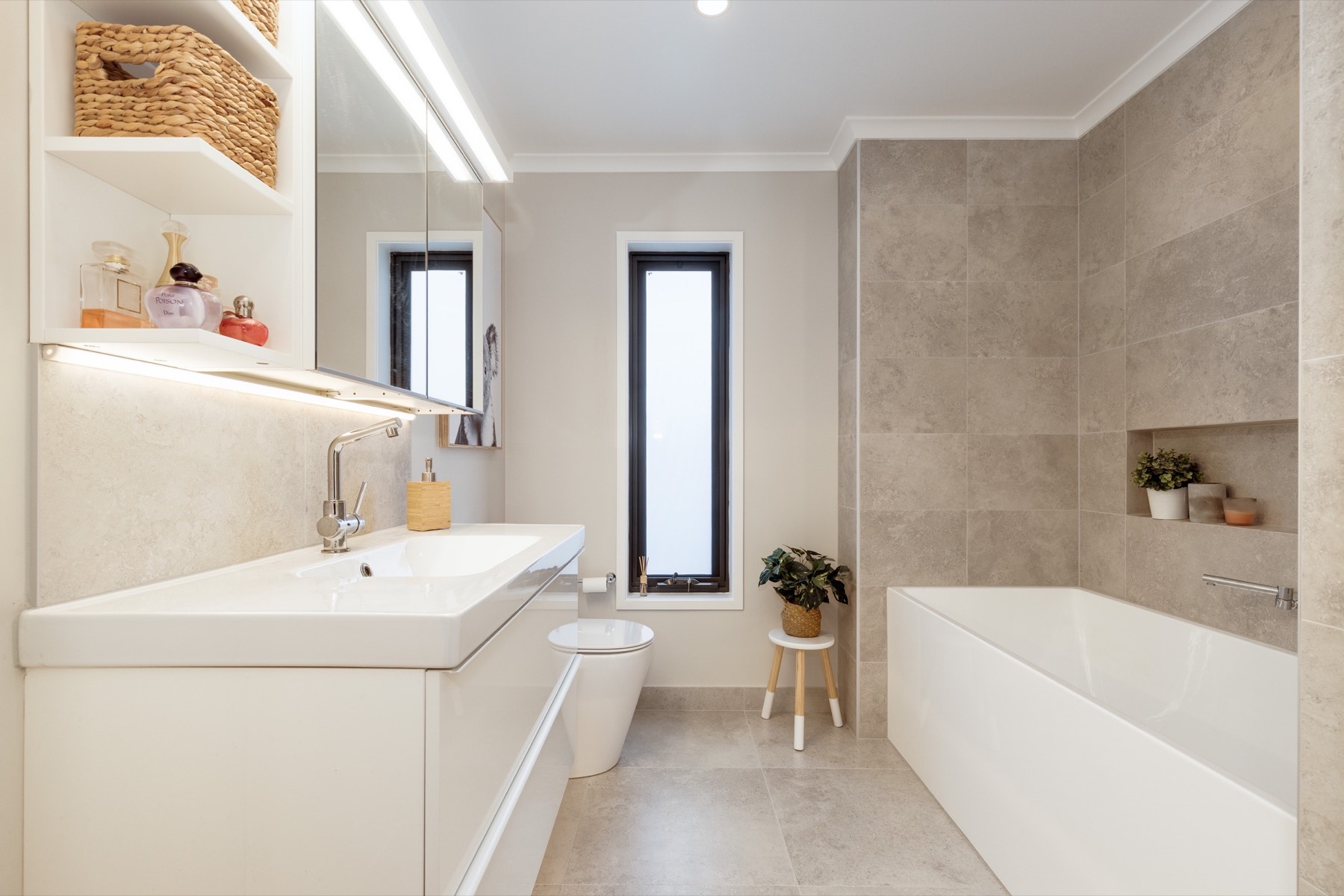 Separate family bathroom with bath, toilet and generous vanity storage