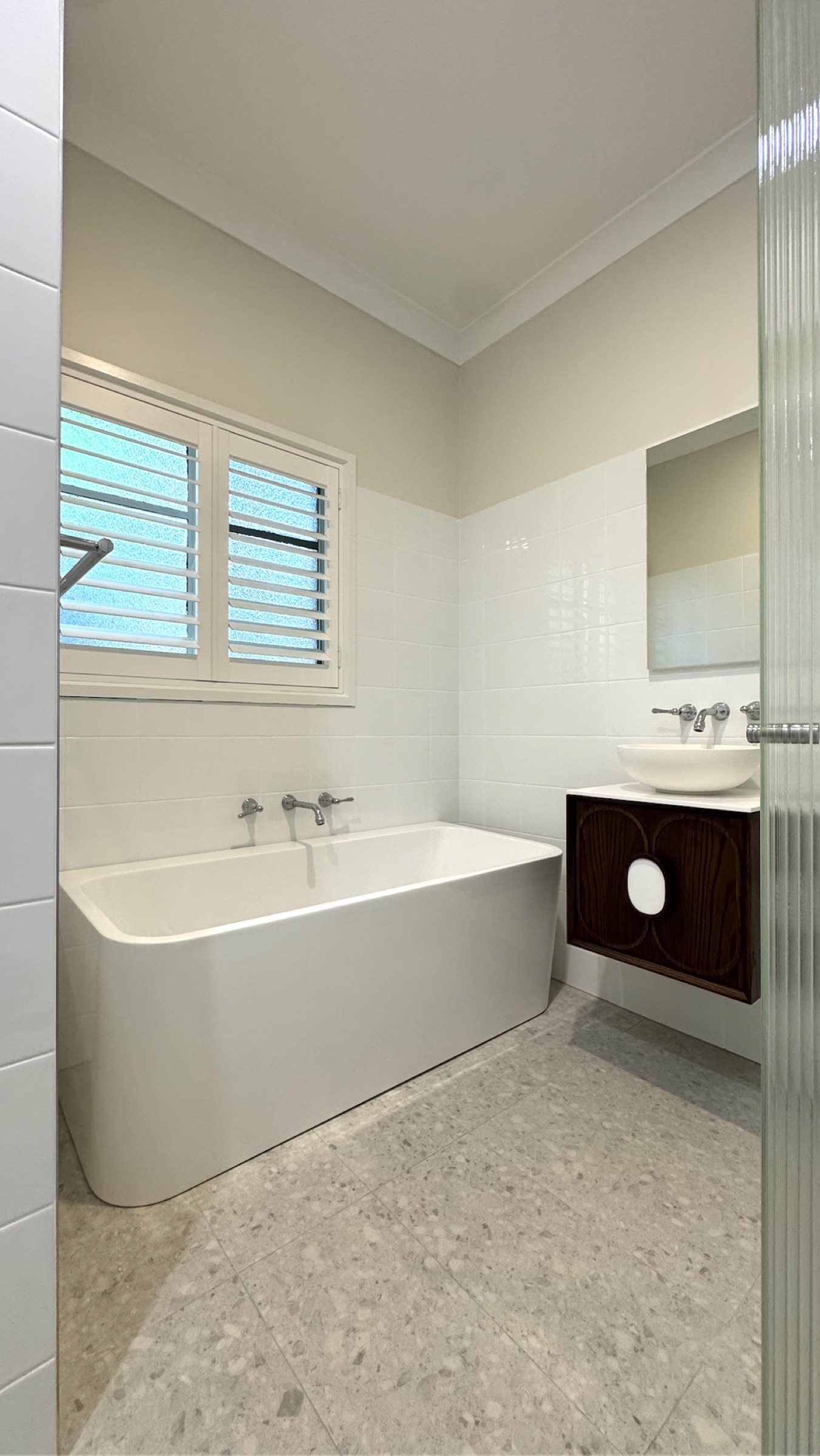 Completed bathroom with freestanding bath, custom timber vanity and fluted glass shower — Clayton