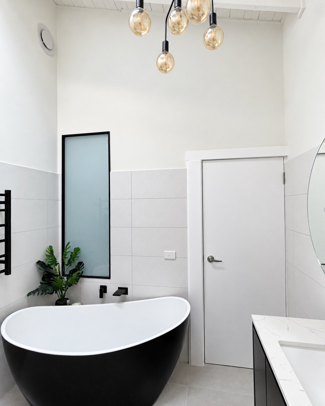 Completed Frankston bathroom with freestanding bath and tall frosted window