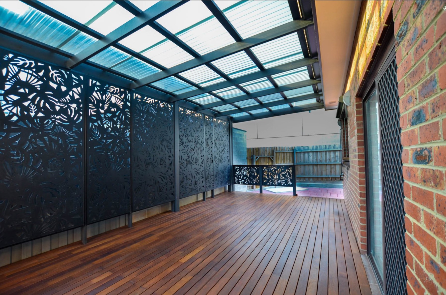 Bonum timber deck with covered pergola and decorative privacy screens