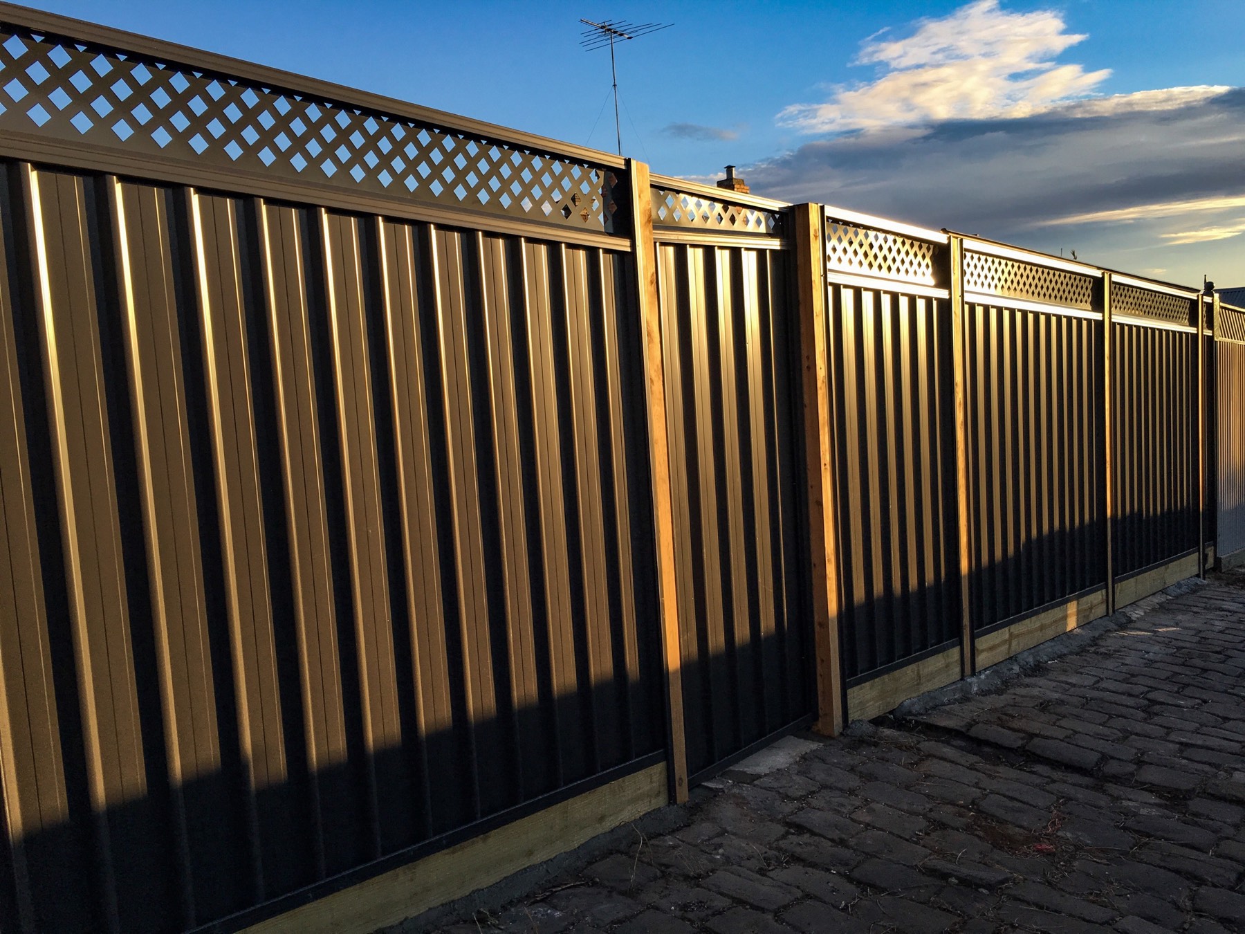 Completed Colorbond boundary fence in the evening light