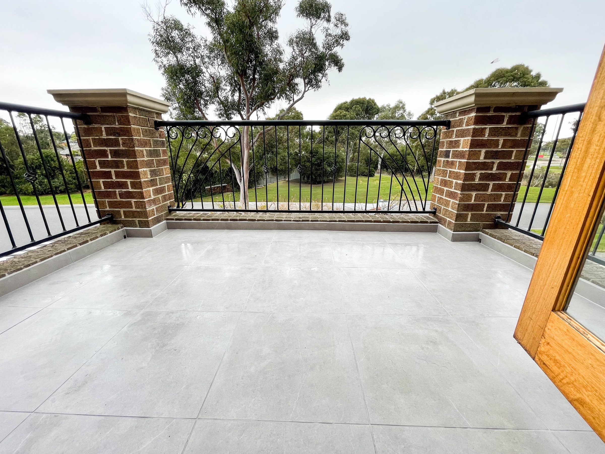 Completed balcony restoration with new large-format tiles — Bayside Melbourne