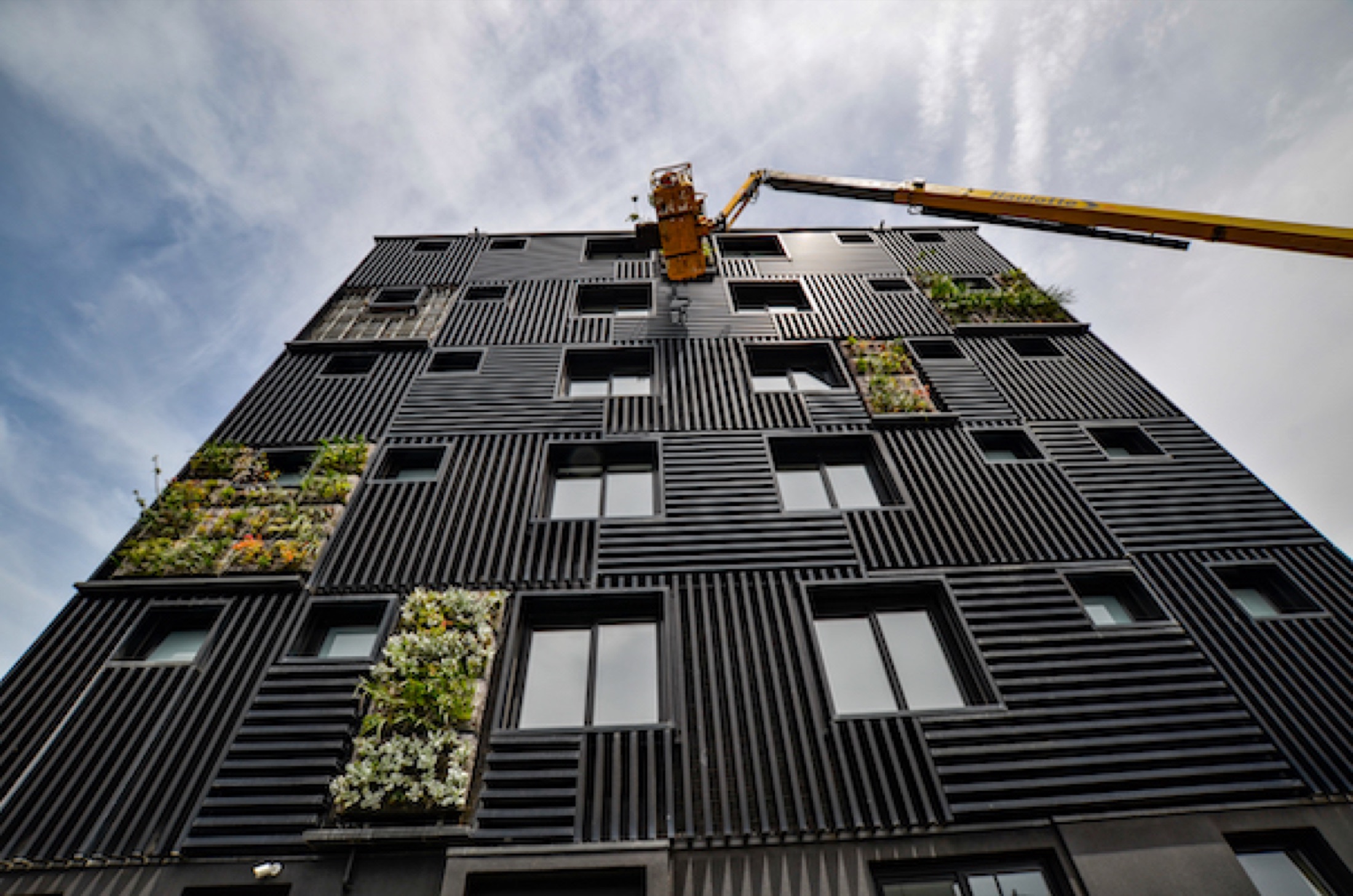 Multi-storey façade with the vertical garden planting restored