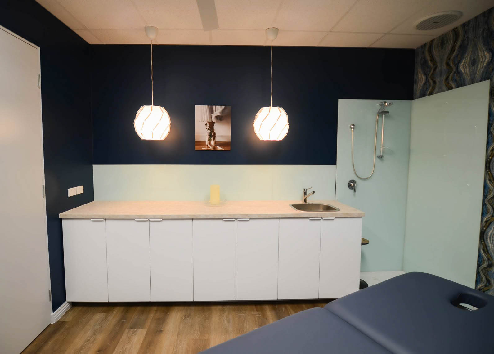Completed Bentleigh massage room with new cabinetry, sink, flooring and shower