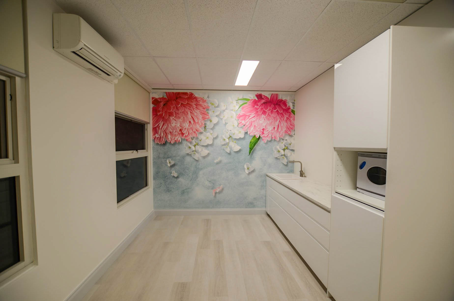 Completed Bentleigh beauty salon with IKEA cabinetry, sink, feature wallpaper, laminate flooring and new air conditioning