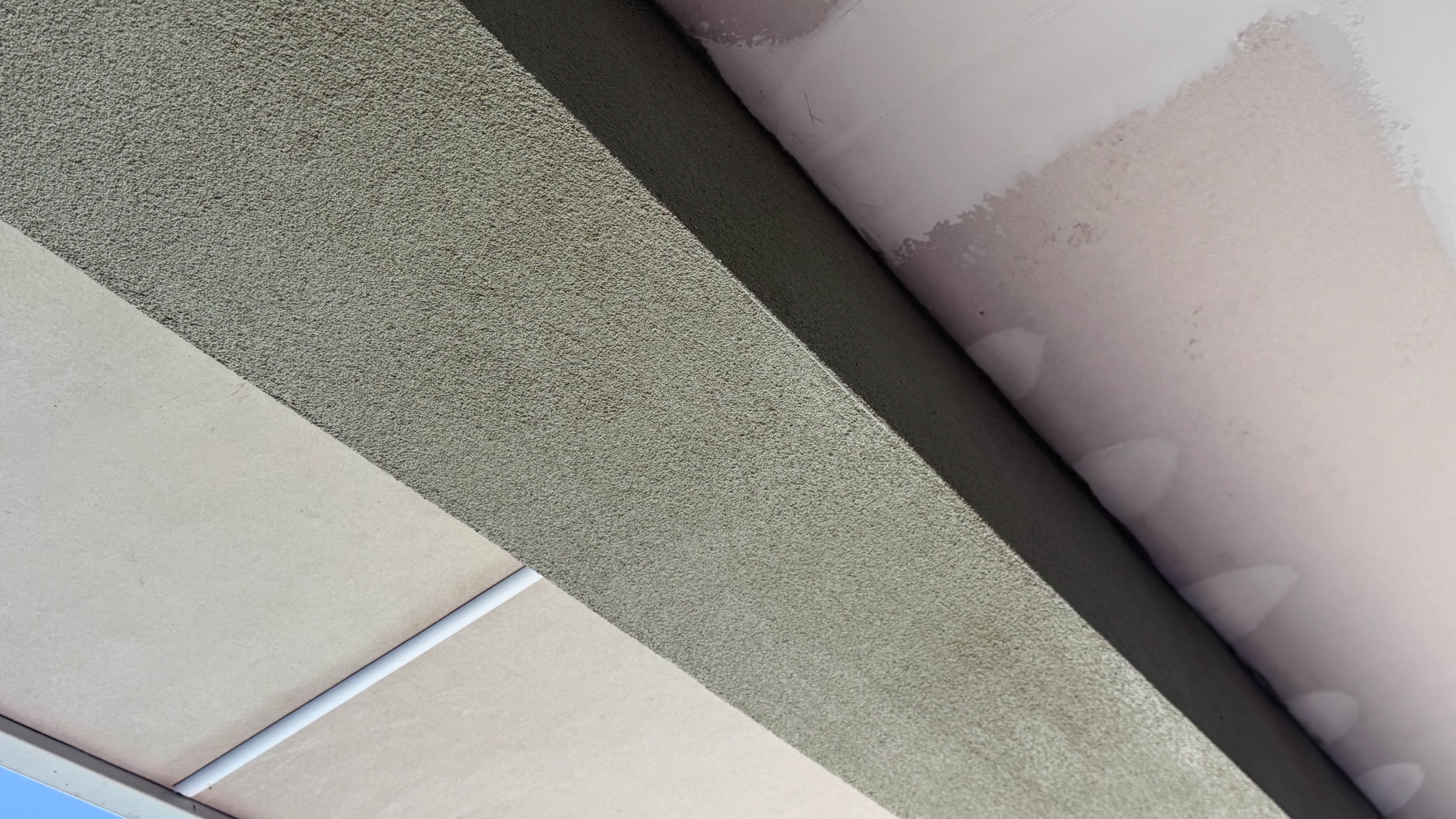 Completed Brighton roof beam replacement with matching rendered and painted finish