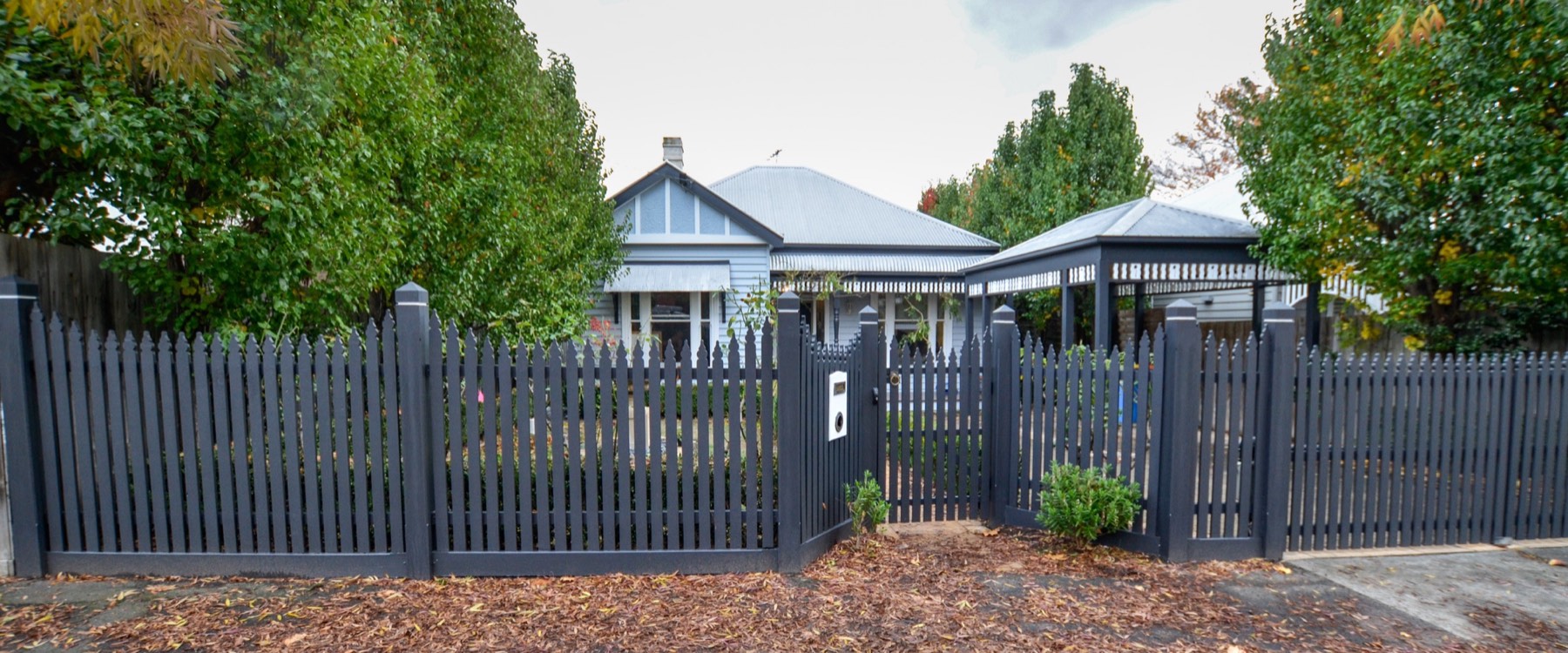 Completed exterior house painting with the renewed front fence and verandah