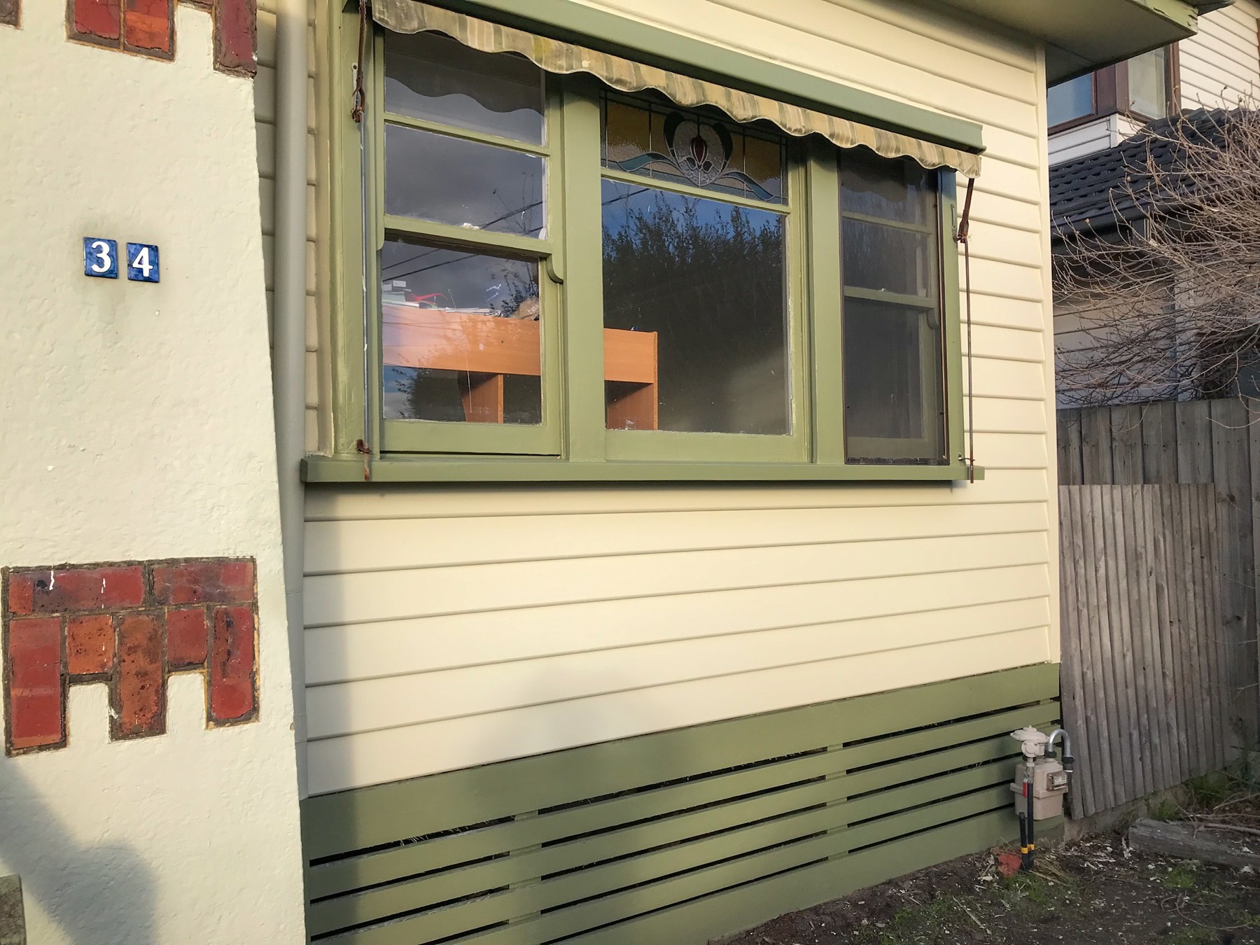 Finished weatherboards and repainted window surround