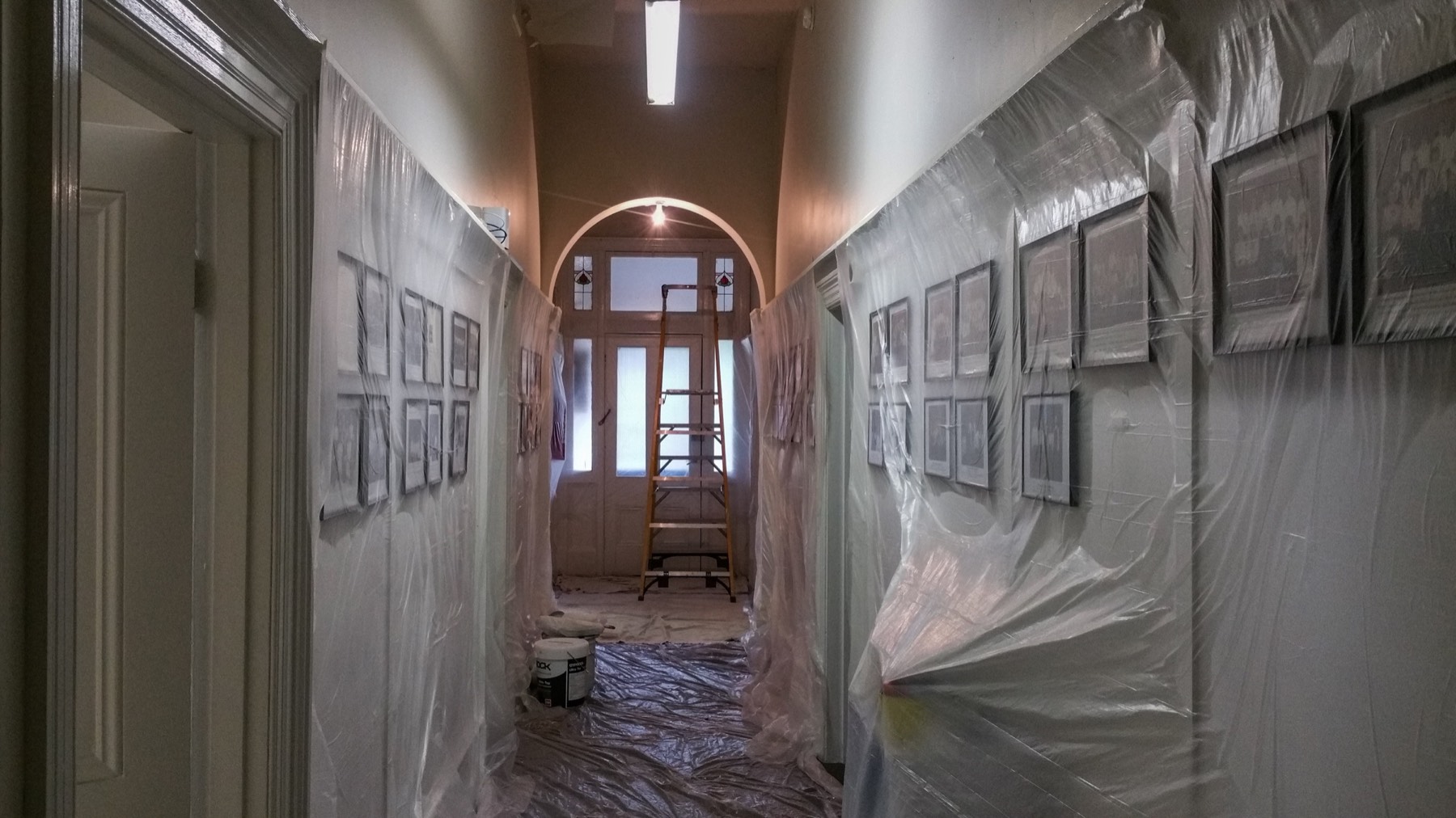 Hallway, doors, artwork and floors protected during painting