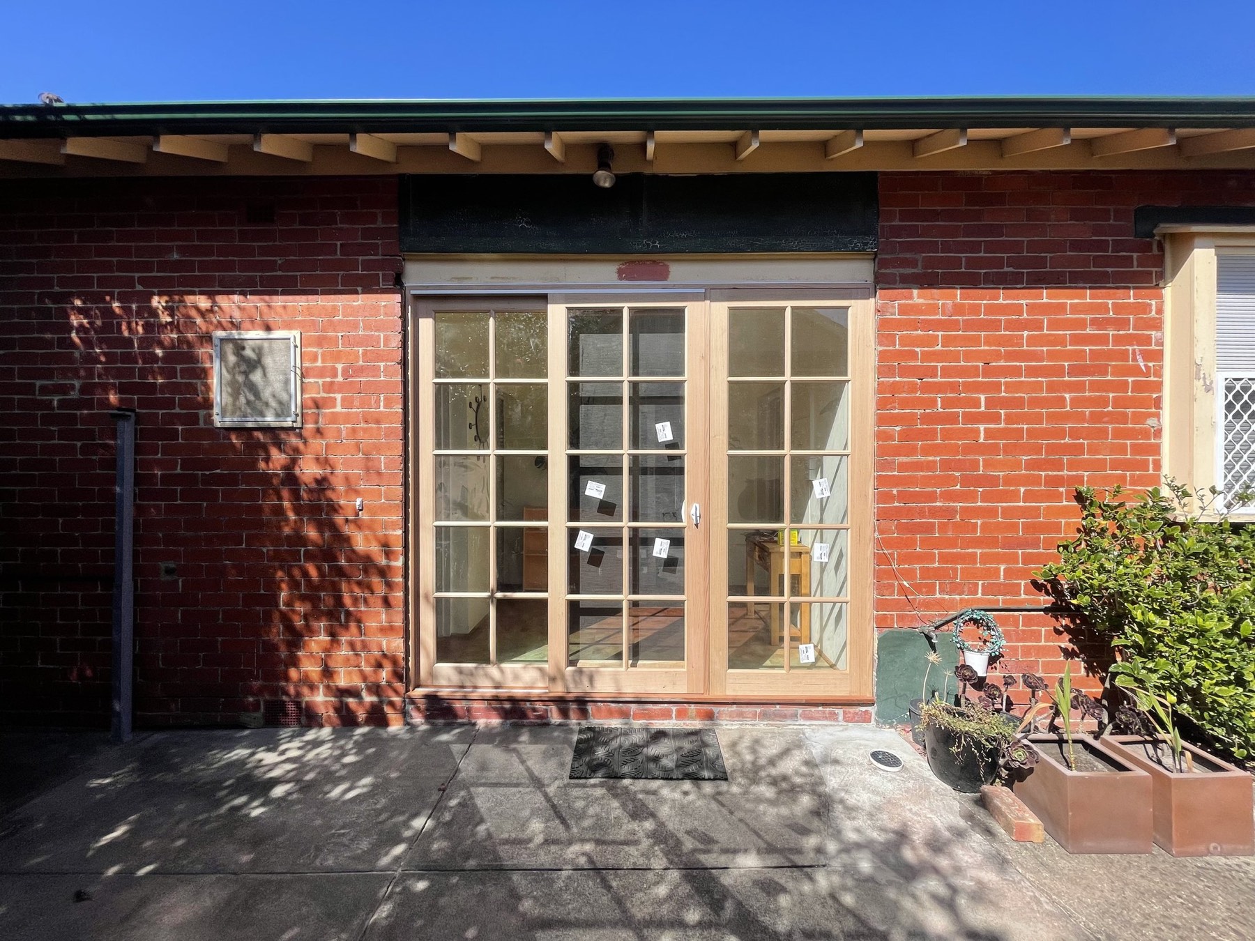 Custom timber French doors installed in the prepared opening