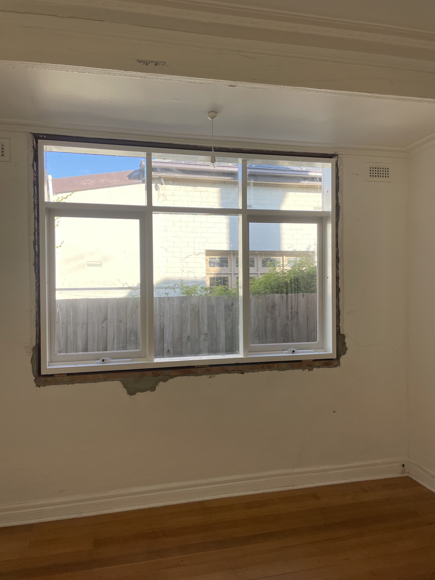New multi-panel window installed securely in the existing opening